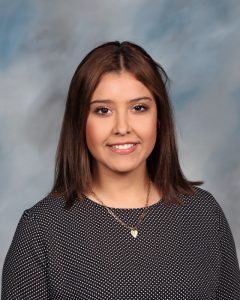 Smiling professional wearing polka dot top against blurred background